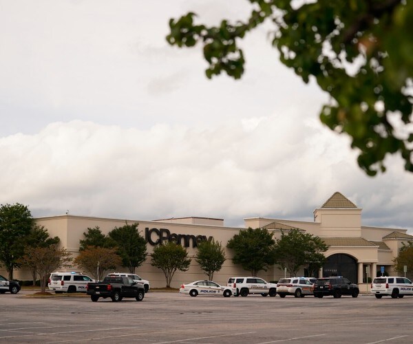 police vehicles parked in front of a jay see penney store