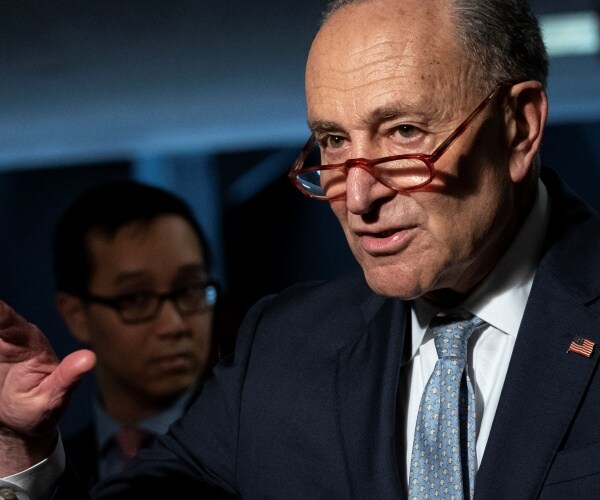 schumer in a navy blue suit and grayish blue tie