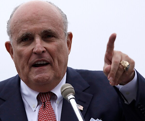 rudy giuliani points forward with his left index finger during a news conference