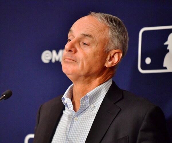 rob manfred stands contrite at a news conference