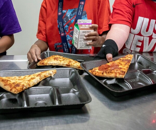 students in line getting food in cafeteria