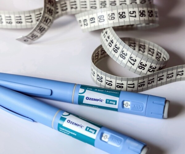 Ozempic pen for weight loss, measuring tape