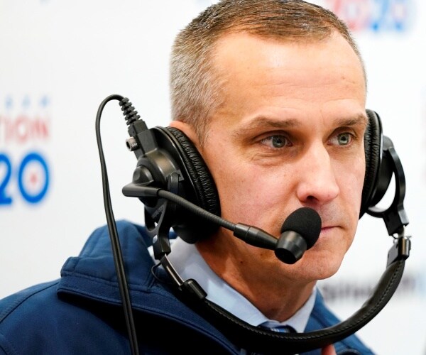 corey lewandowski wears a head set and speaks