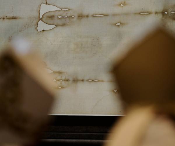 two bishops heads in front of the shroud of turin