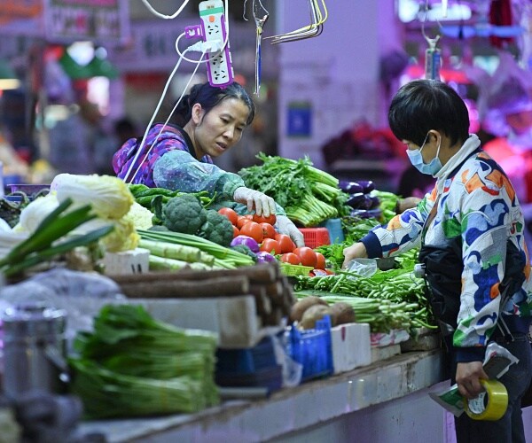 person buying vegetables