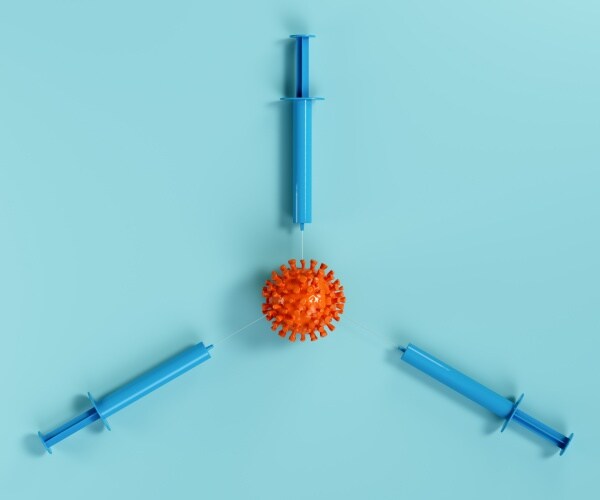 3 syringes pointing at the coronavirus