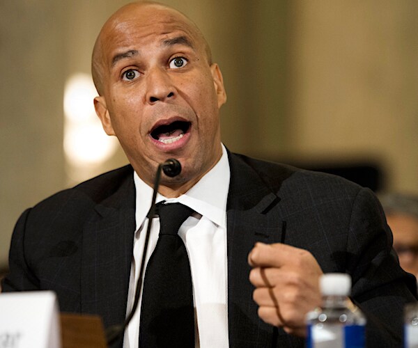 cory booker pounds the table emphatically during a senate hearing