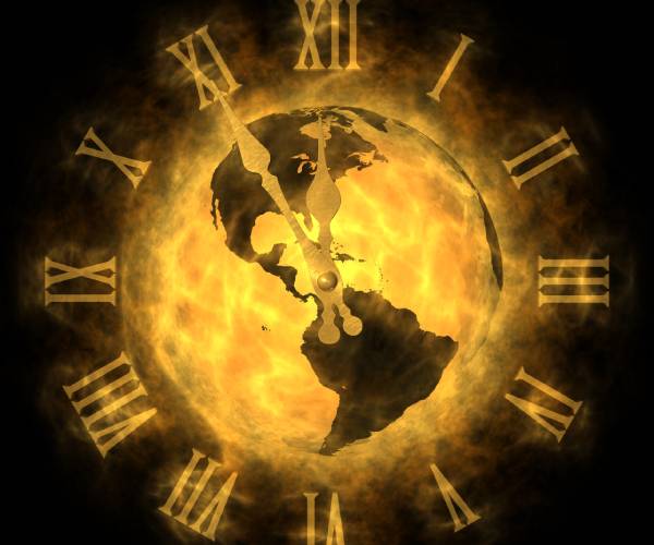 a clock set five minutes till midnight with a overheated earth as the clock