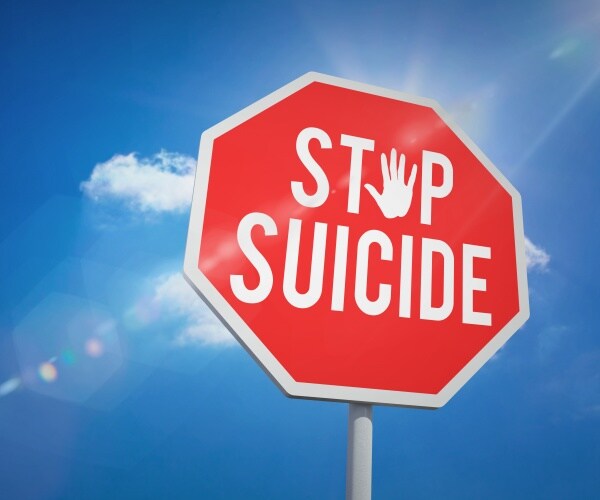 stop sign says 'stop suicide'