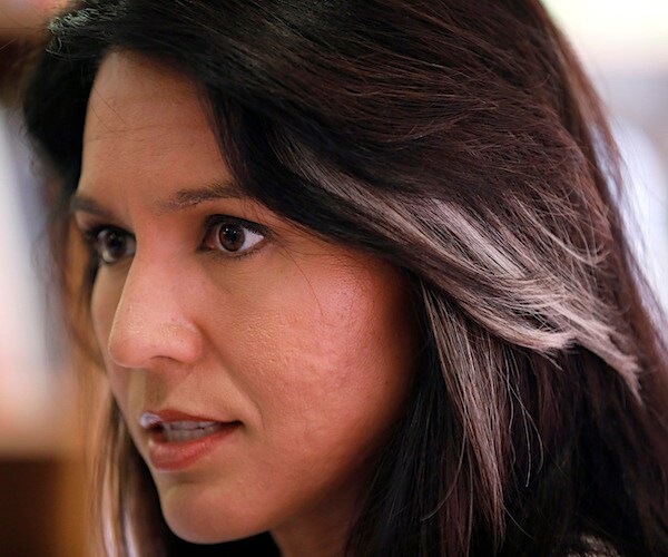 gabbard looks on as she speaks to the media during a news conference