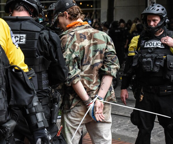 police arrest a protester in portland oregon.