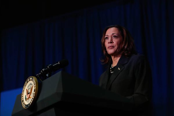 Vice President Kamala Harris stands behind a podium.