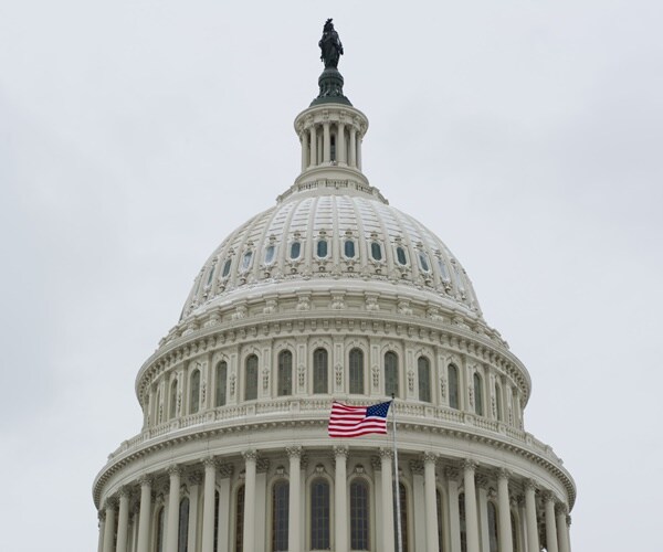 the capitol dome with an american flag flying in front