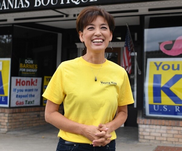 kim in a yellow t shirt smiling