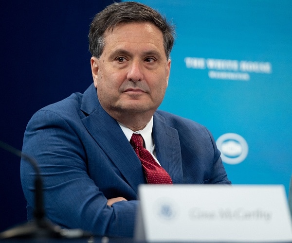 ron klain sits at table with arms folded