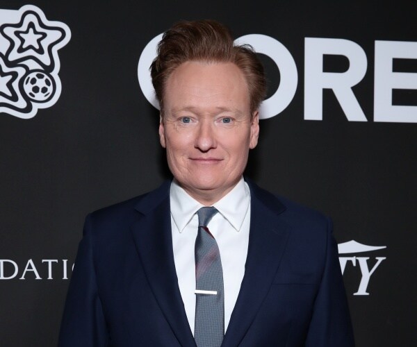 conan obriend stands on red carpet