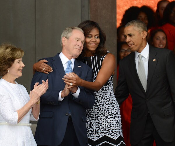 michelle obama hugs former president george double you bush in a famed photo during the 2016 presidential election