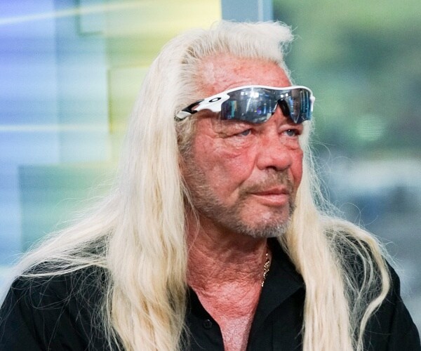 duane chapman sits on couch in tv set