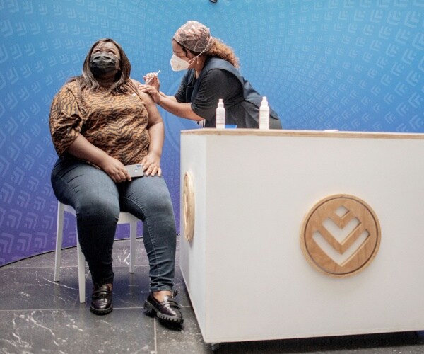 A woman receives a dose of the Pfizer/BioNTech vaccine