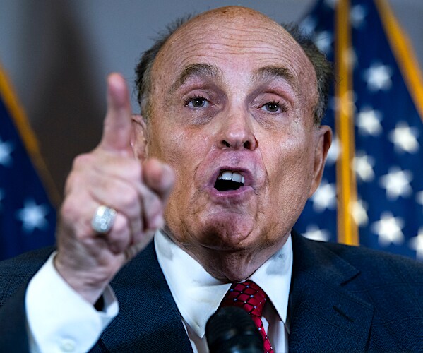 rudy giuliani points and delivers remarks at a trump campaign election challenge news conference