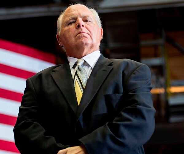 rush limbaugh looks down from stage