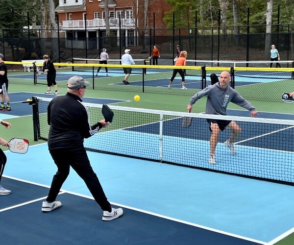 4 people playing pickleball