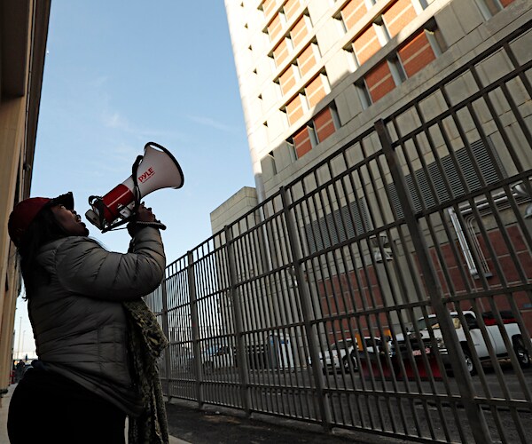 A woman protester shouts outside lower Manhattan's maligned Metropolitan Correctional Center