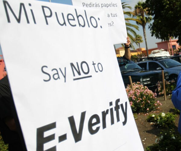 file photo showing a sign to protest the use of e-verify by mi pueblo food center in california.