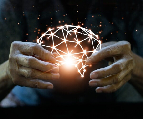 scientist holding lit up hologram of the brain