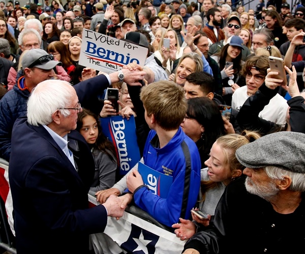 bernie sanders shakes hands with supporters