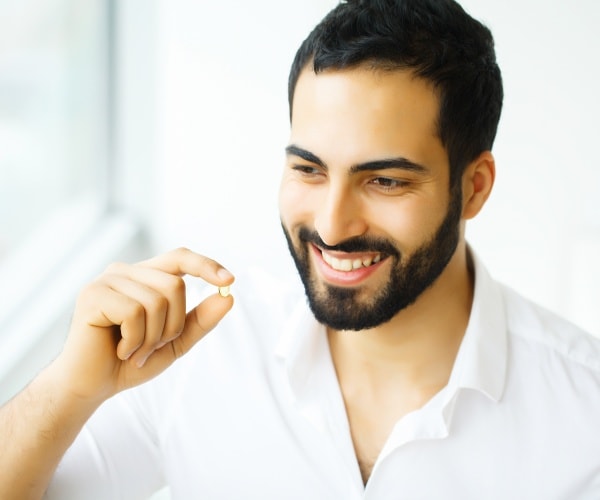 man taking a vitamin