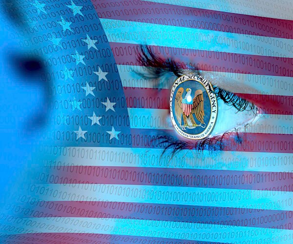 the national security administration's logo is seen in the eyeball of a man whose face is brushed with an american flag