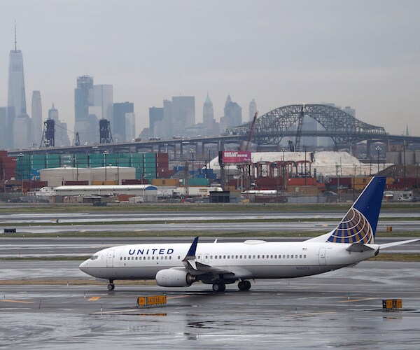 a united airlines jet taxis on a runway 