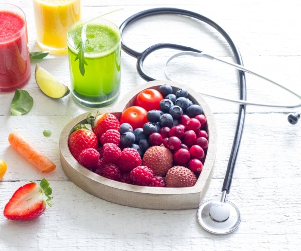 fruit in a heart-shaped bowl, juices, stethoscope