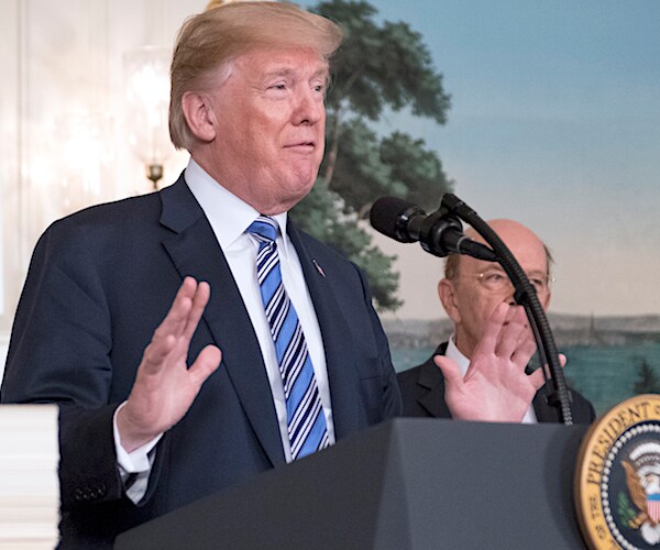 president donald trump holds up both hands with palms forward during a news conference