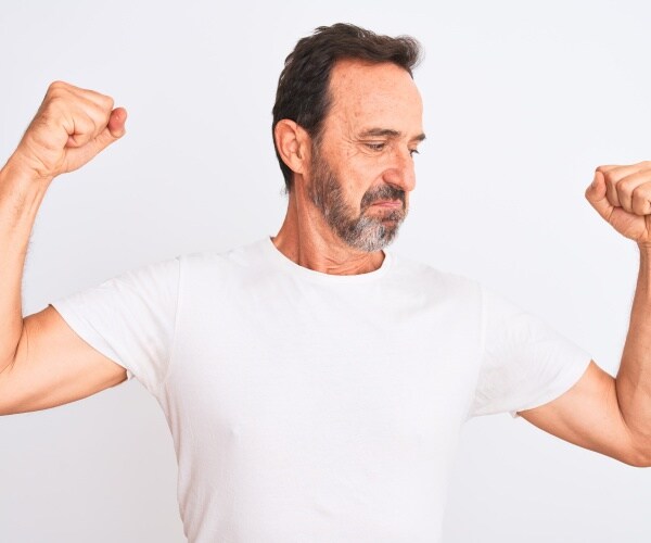 man in t-shirt flexing muscles