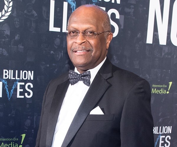 herman cain pauses for the camera at a billion lives premier