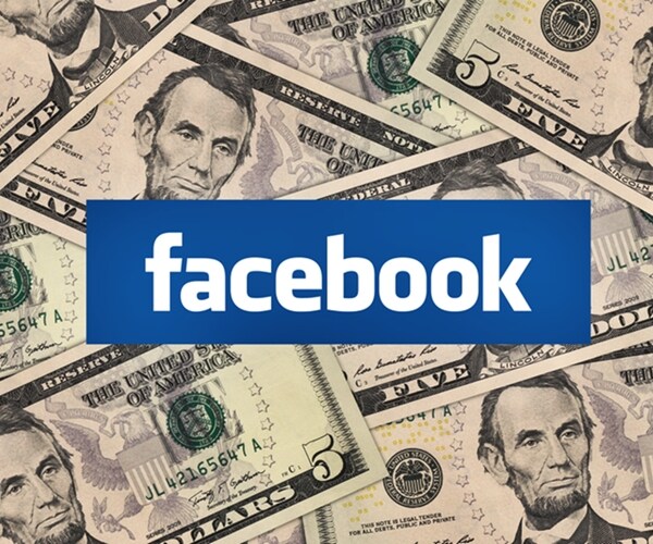 facebook logo symbol among five dollar bills