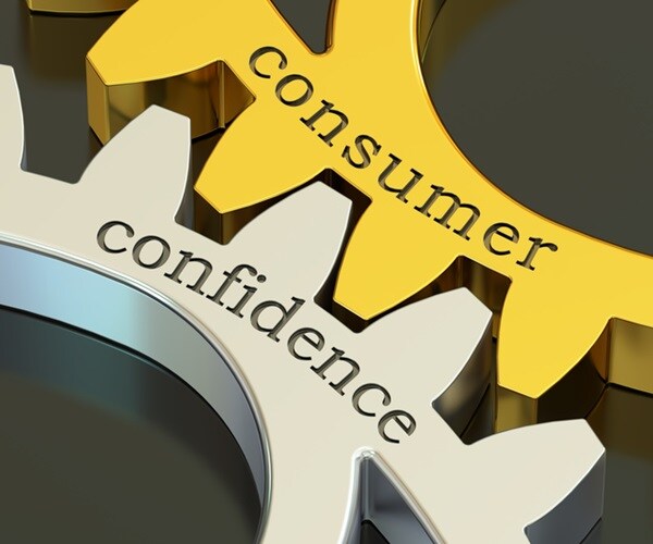 consumer confidence printed on gold and silver gearwheels