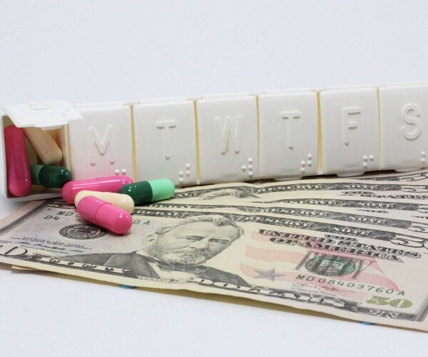 pill box with $50 bills below it