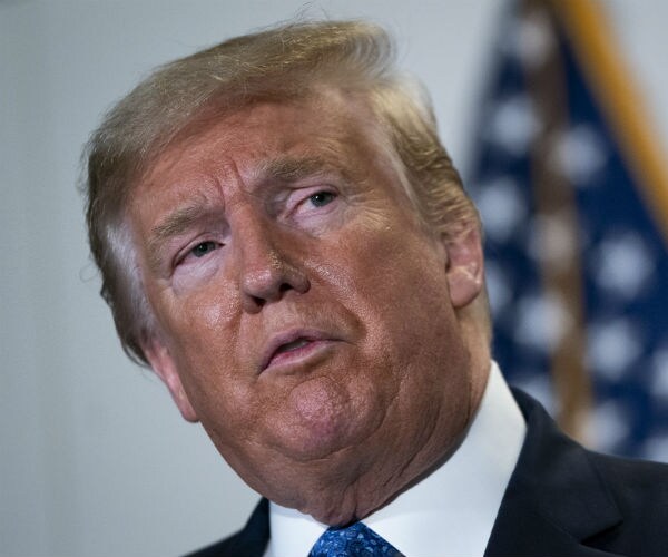 president donald trump is seen in dress shirt, suit and blue tie