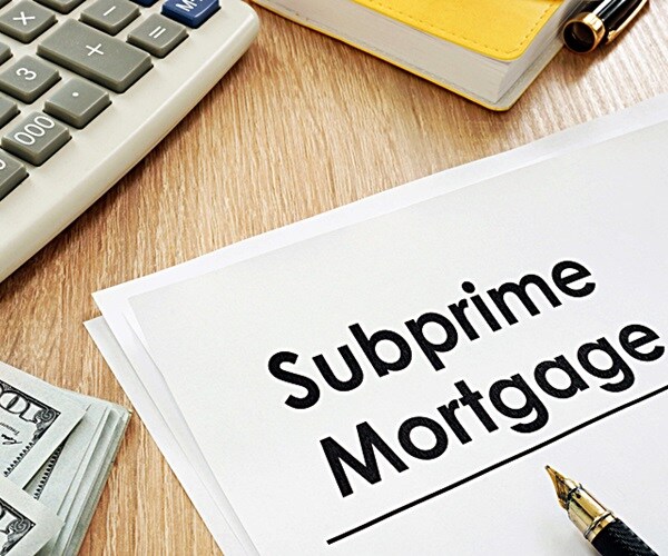 subprime mortgage form, calculator and pen. 