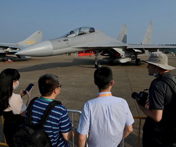 visitors looks at fighter jet