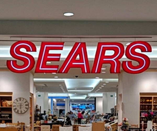 sears logo in red neon on store front