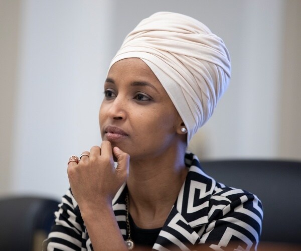 omar in a black and white patterned blazer and white head scarf