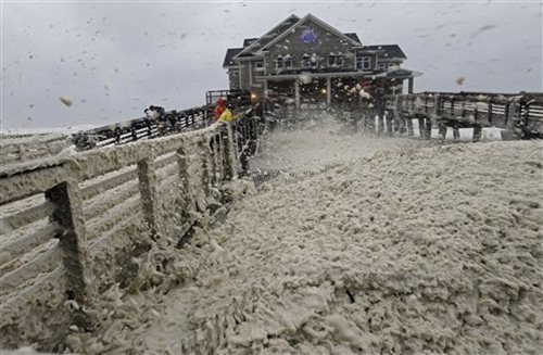 High Winds Blow Sea Foam Onto Pier 