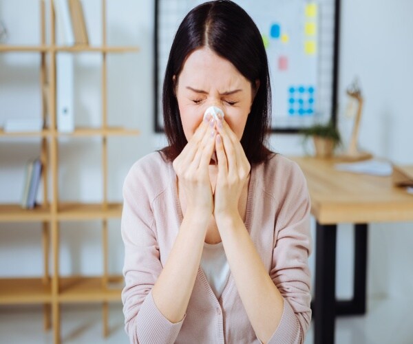 a woman sneezing