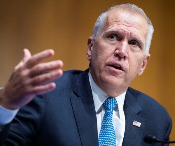 tillis in a suit and blue patterned tie speaking at a hearing