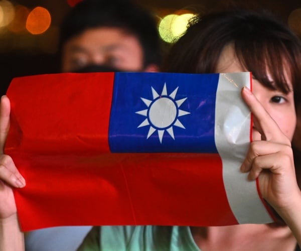 woman holds a taiwanese flag