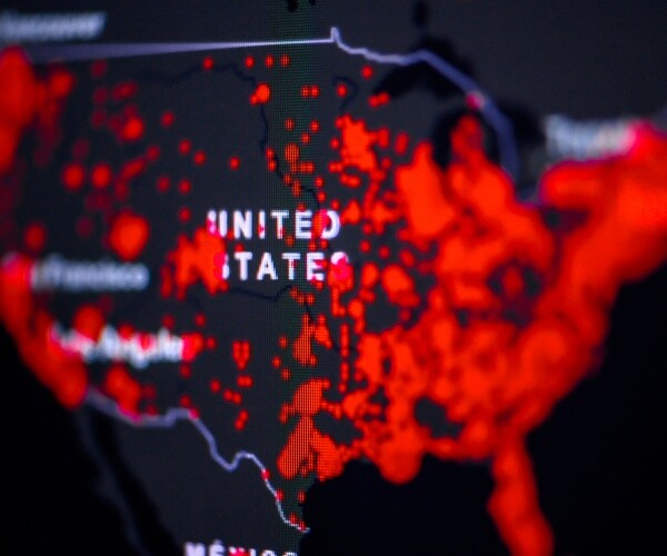 United States map with red dots of COVID cases